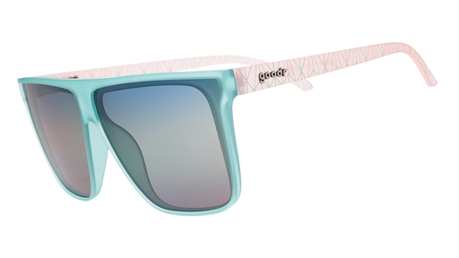 Light blue sunglasses with blue-pink gradient lenses and pink patterned temple arms on blue.