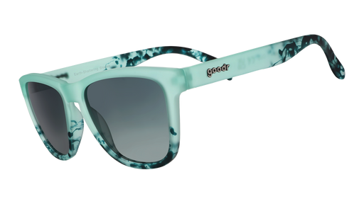 Three-quarter angle view of translucent green sunglasses with dark green hand-painted swirls and gradient lenses.