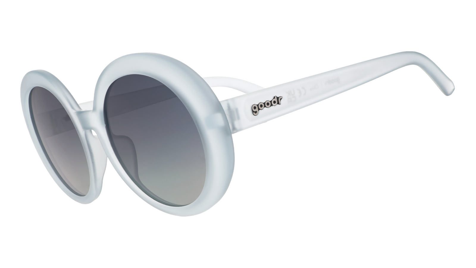 Three-quarter angle view of oversized round sunglasses with translucent blue frames and silver reflective gradient lenses.