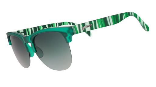 Green translucent sunglasses with mirrored lenses and striped temple arms on a blue patterned background.