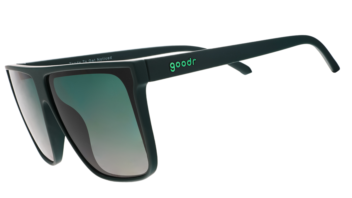 Three-quarter angle view of deep green oversized flat-top sunglasses with green gradient lenses.