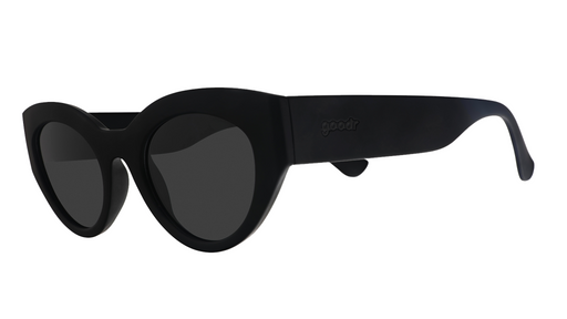 Three-quarter angle view of translucent black, retro-inspired angled cat-eye sunglasses with non-reflective lenses.