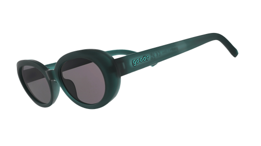 Three-quarter-angle view of translucent dark green Beat G sunglasses with black non-reflective lenses. 