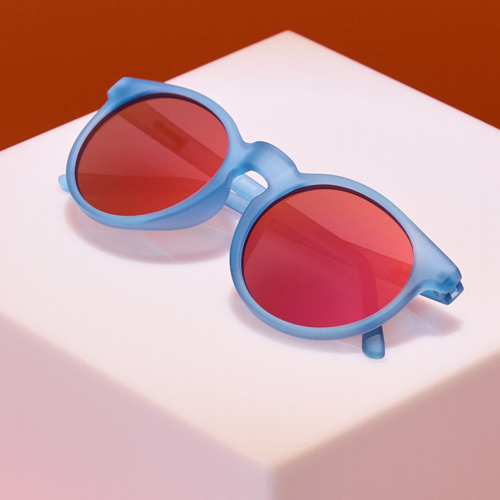 Dusty blue Circle G sunglasses with red reflective lenses