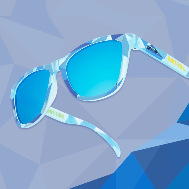 Three-quarter angle back view of blue shades w/geometric pattern, Boston printed on temples+blue reflective lenses.