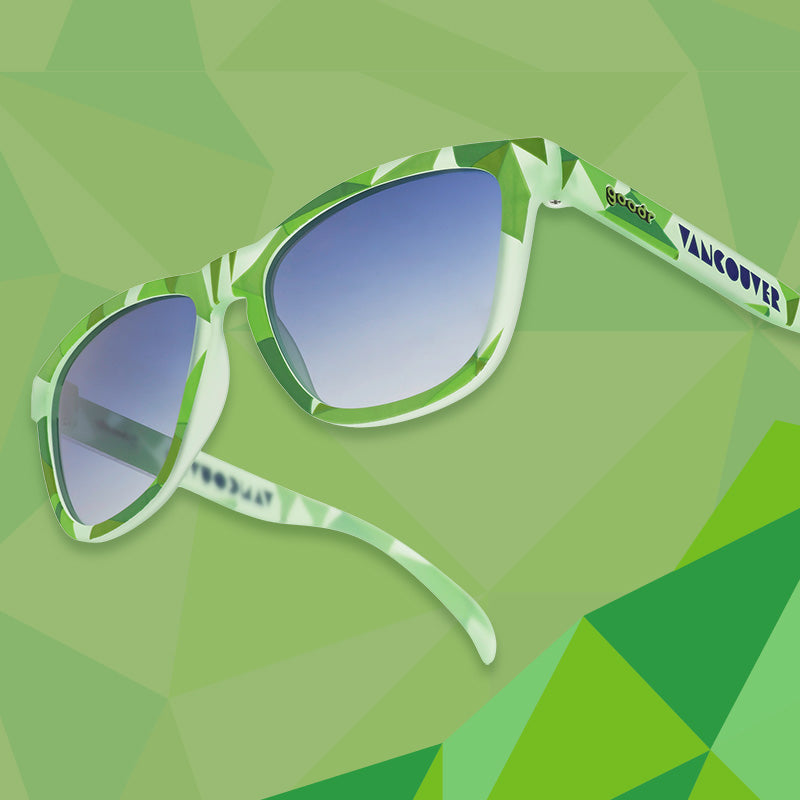 Three-quarter angle view of light green shades w/ geometric pattern, Vancouver printed on temples+blue gradient lenses.