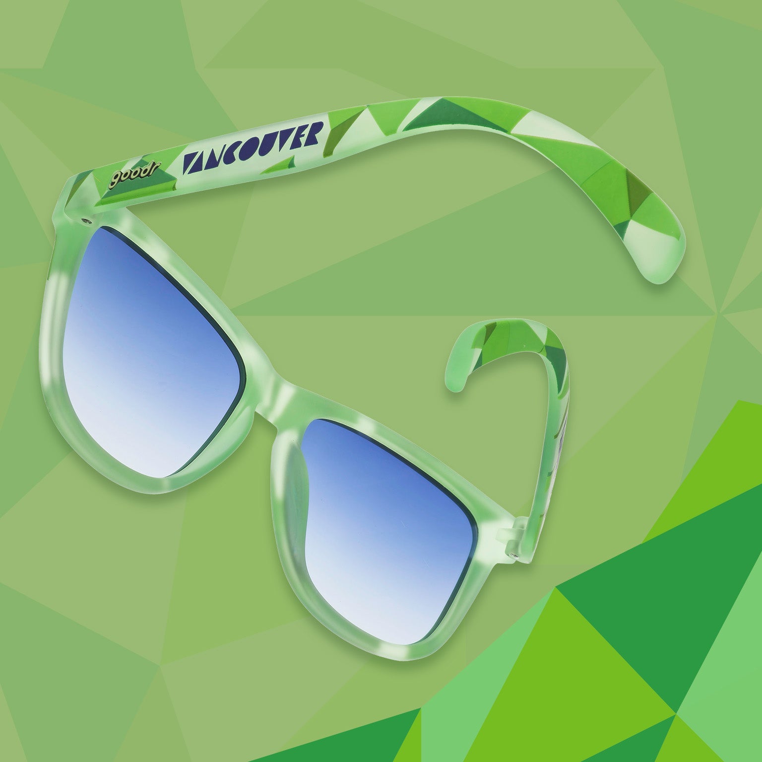 Three-quarter angle view of light green shades w/ geometric pattern, Vancouver printed on temples+blue gradient lenses.