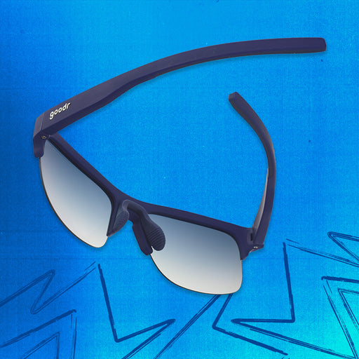 Three-quarter angle back view of navy blue shades with blue gradient lenses tilted down on a blue background.
