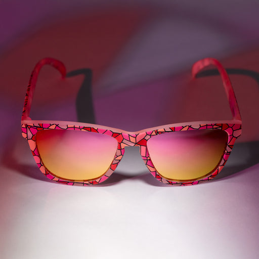 A pair of pink OGs with a multi-colored stained glass design on a white backdrop with a stained glass lighting effect.