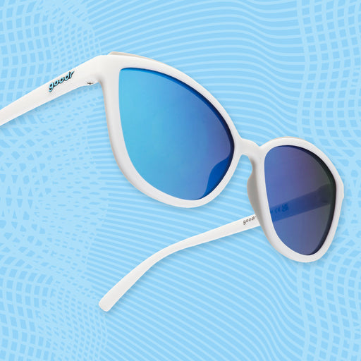 Side view of white cat-eye sunglasses with light blue mirrored lenses and minimalist white frames.