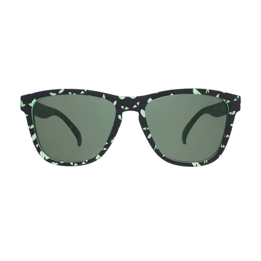 Three-quarter view of green-and-black sunglasses with an eerie glowing eyes design and non-reflective green lenses.
