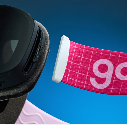  Close-up of pink grid-pattern goodr goggle strap attached to black ski goggles.